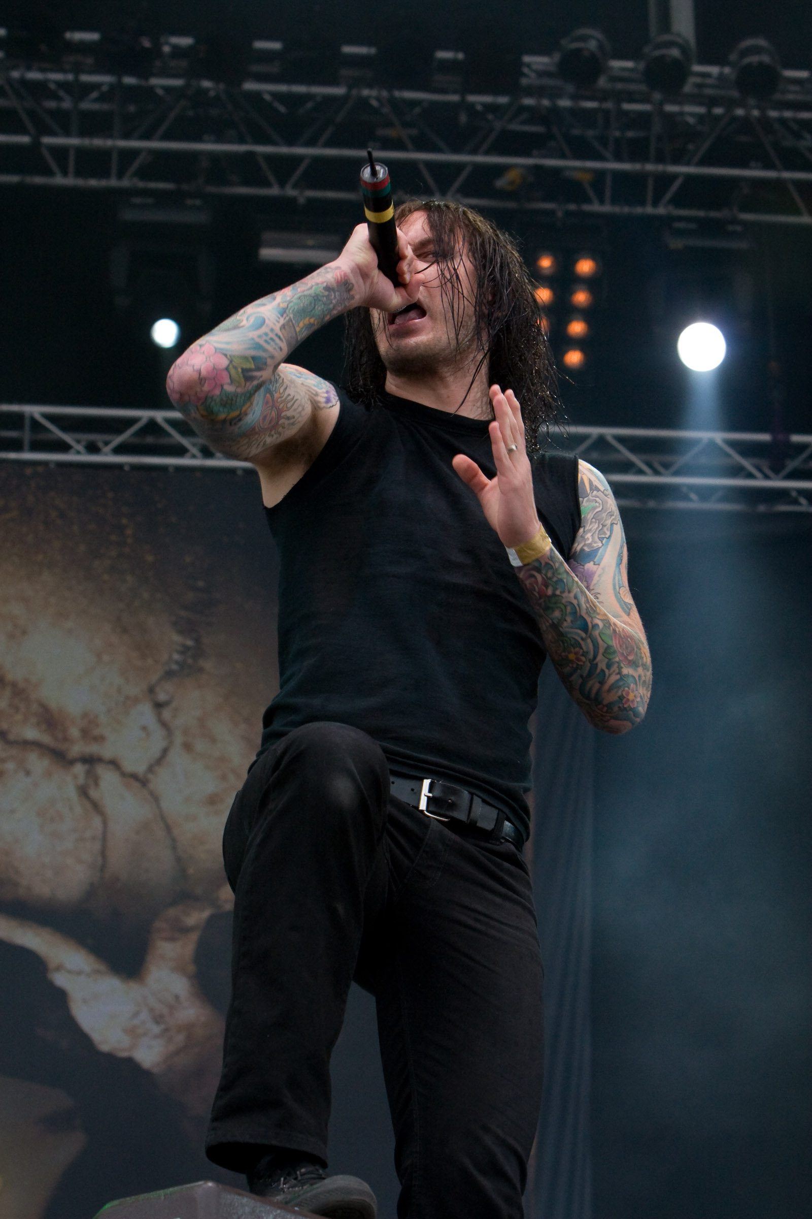 Close view of Tim Lambesis colorful forearm tattoos on stage