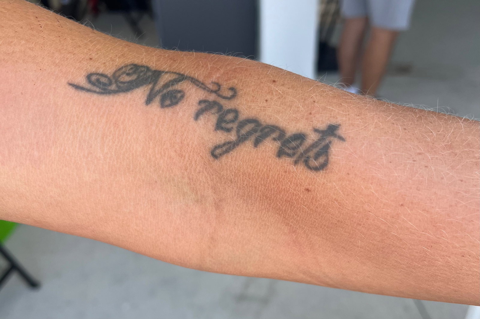 Tina Pisnik tattoos: close evidence of the documented forearm lettering and symbolic tattoo style