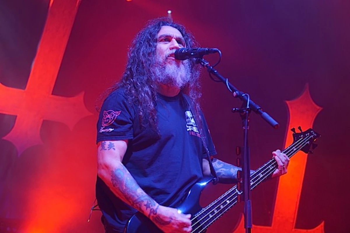 Tom Araya forearm tattoos under red stage lights