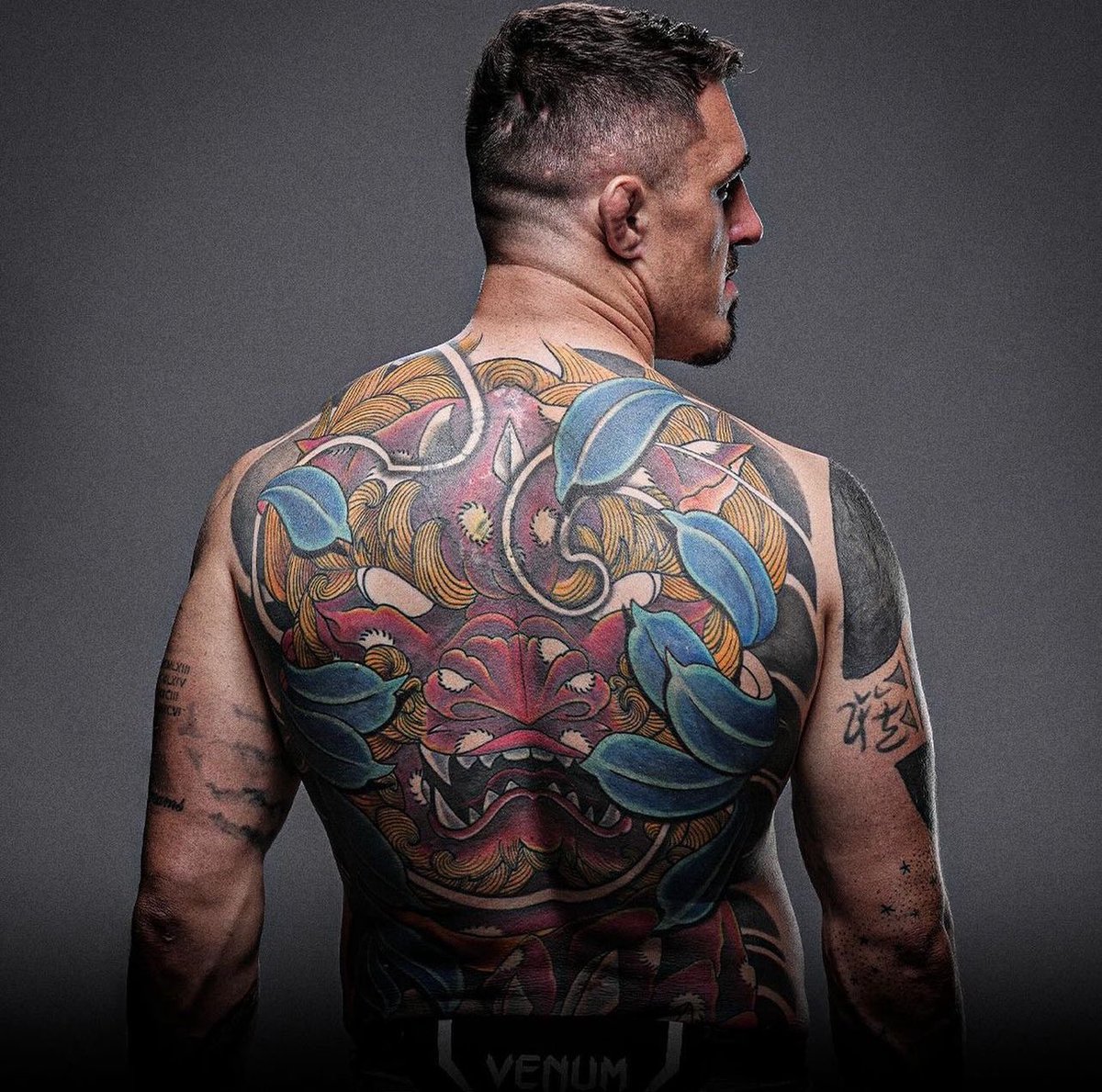Tom Aspinall tattoos: large colourful demon-style back piece