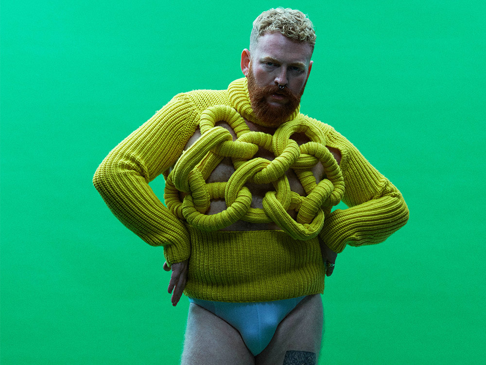 Tom Rasmussen yellow and green promotional portrait Tom Rasmussen in a contextual photograph: inline; not tattoo evidence