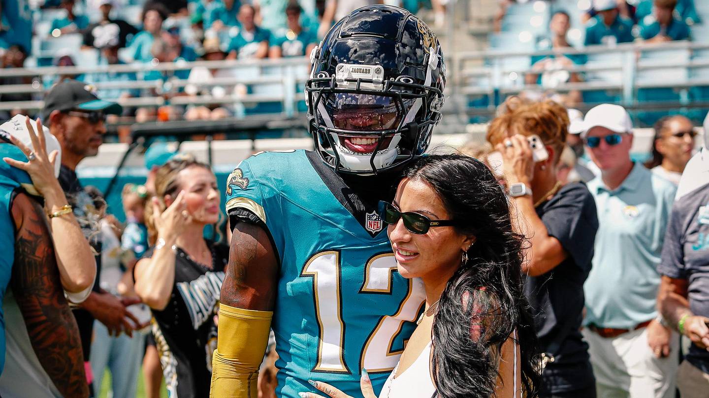 Travis Hunter in a contextual photograph: Contextual family and football image; explicitly not tattoo evidence.; not tattoo evidence
