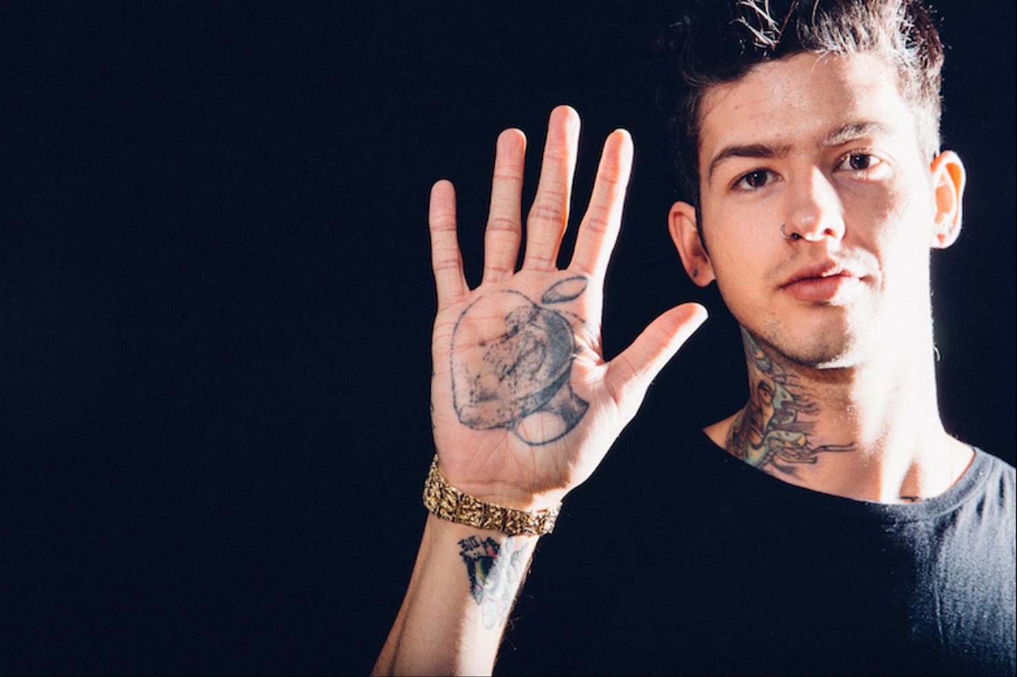 Travis Mills colorful forearm and hand tattoos