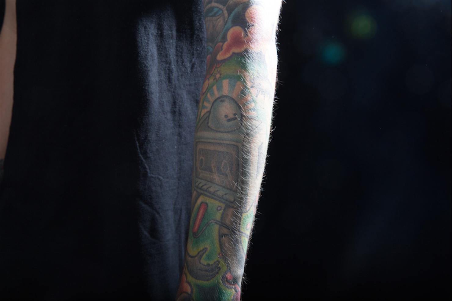 Travis Mills colorful tattoo sleeve close-up