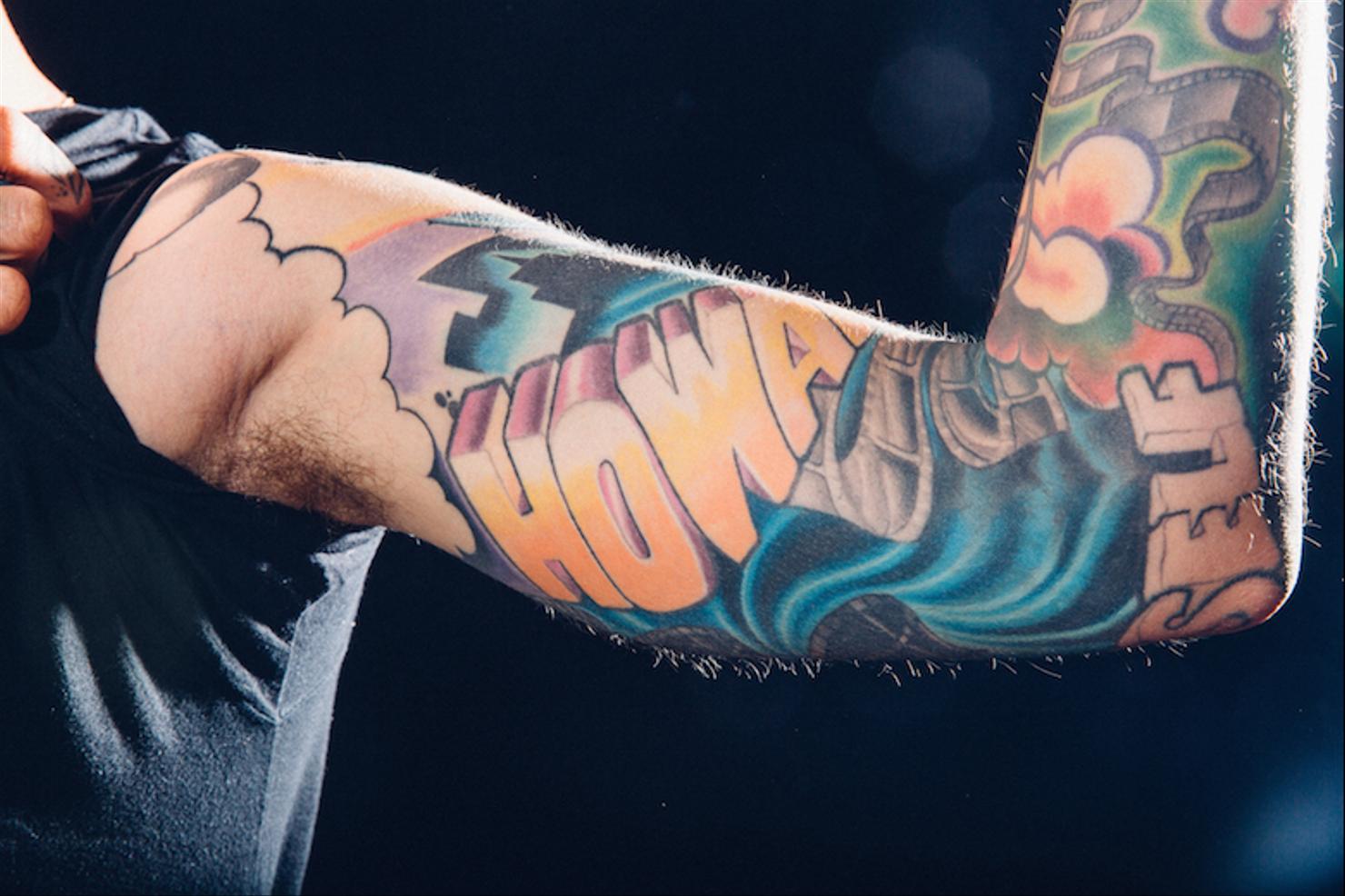 Travis Mills colorful upper arm tattoo lettering