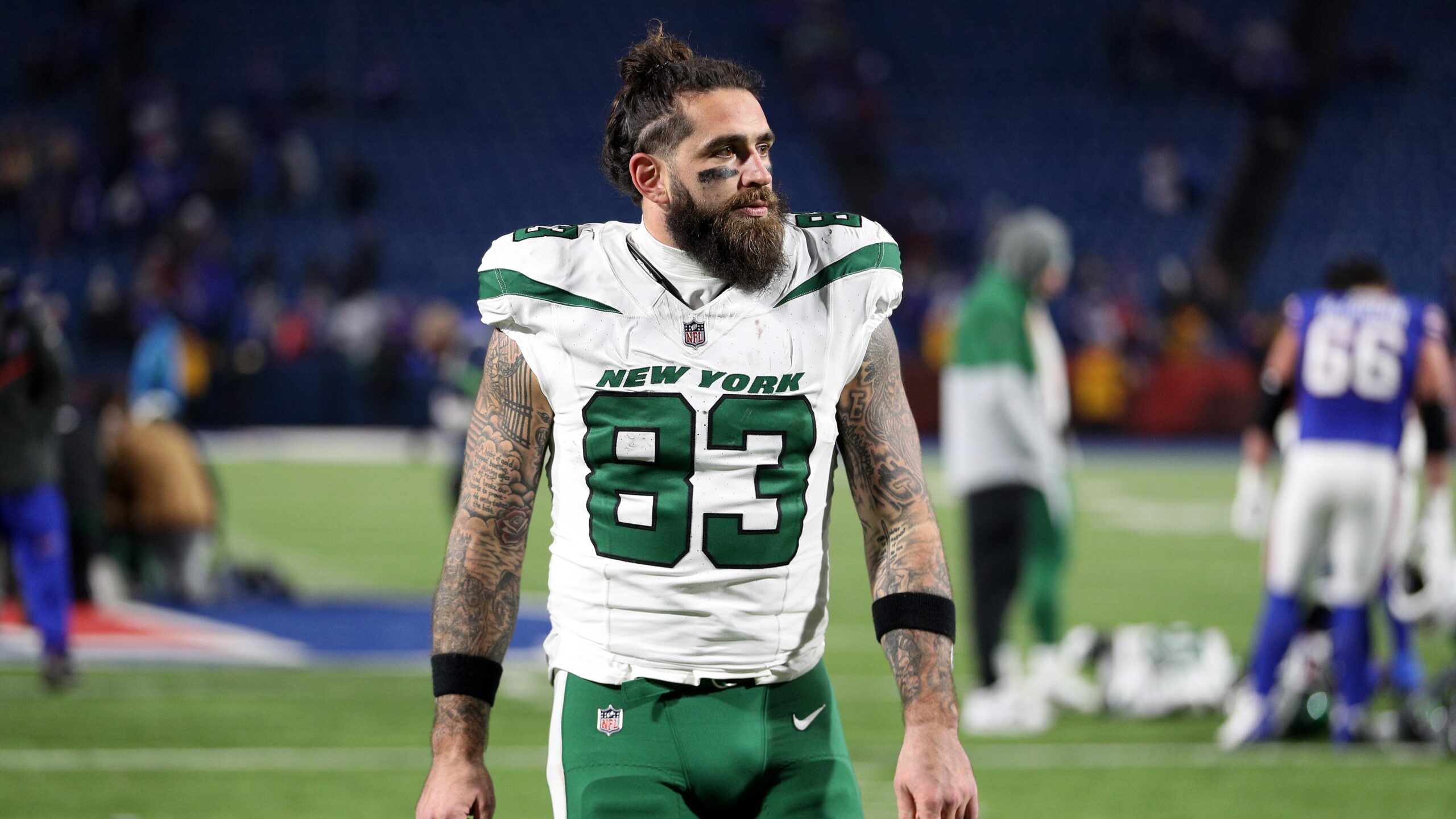 Tyler Conklin Full arm coverage, script and black-and-grey sleeve structure in a high-resolution Jets postgame photograph Tyler Conklin tattoos: Full arm coverage, script and black-and-grey sleeve structure in a high-resolution Jets postgame photograph