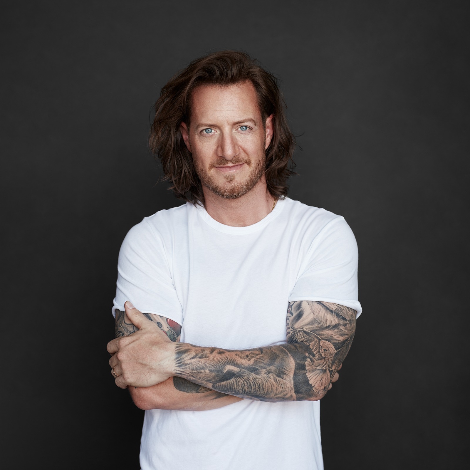 Tyler Hubbard tattoos: broad view of Tyler Hubbard’s tattooed arms