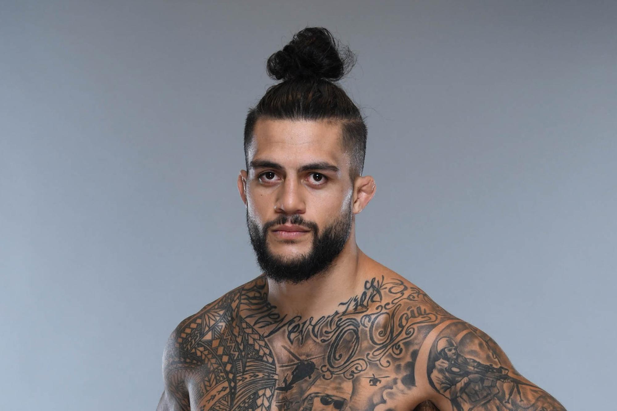 Tyson Pedro tattoos: Official UFC portrait showing the shoulder lettering, chest script and upper-body tattoo layout.