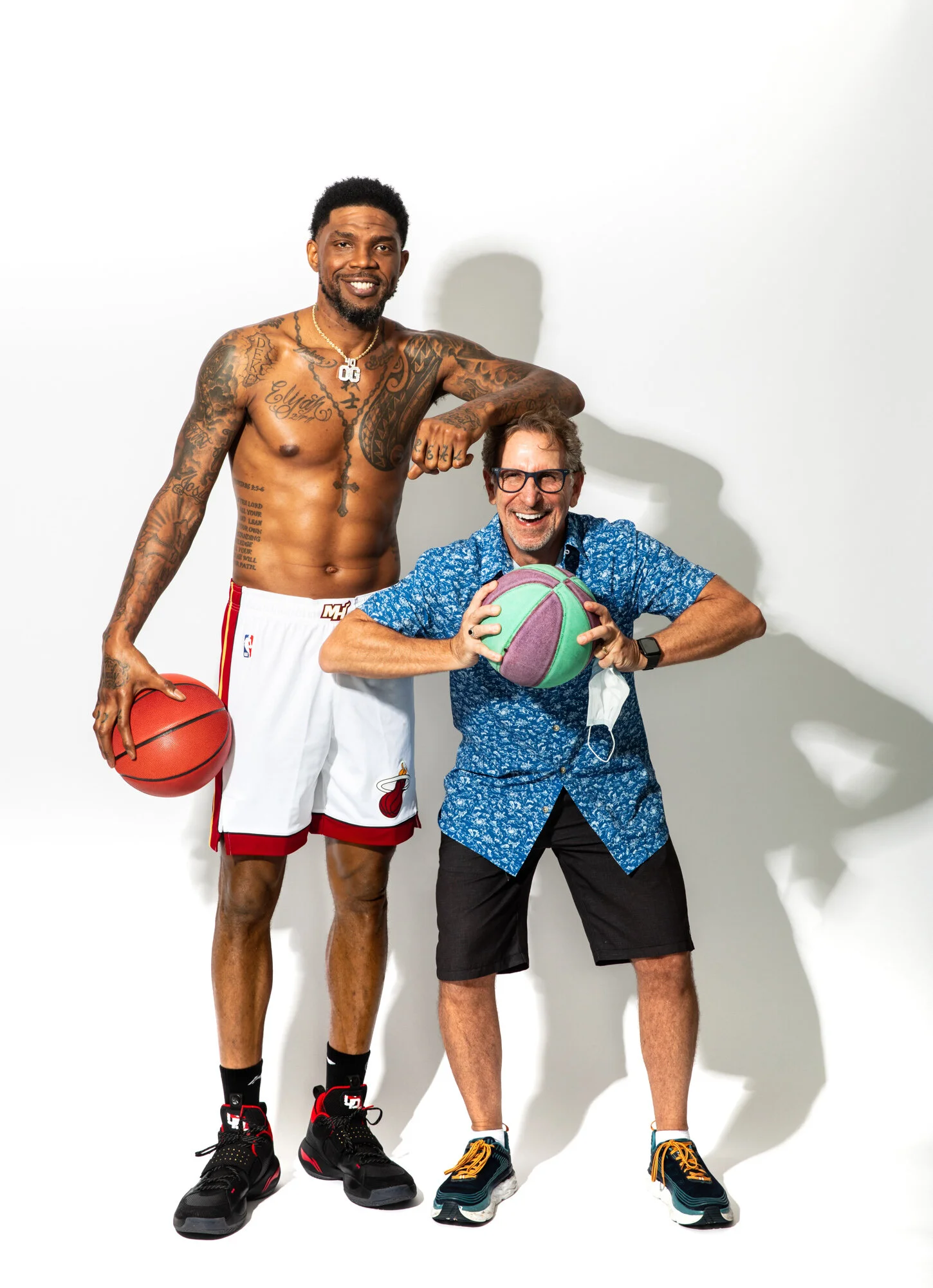 Udonis Haslem tattoos: shirtless portrait showing the full torso, shoulder patterns and script running down the body