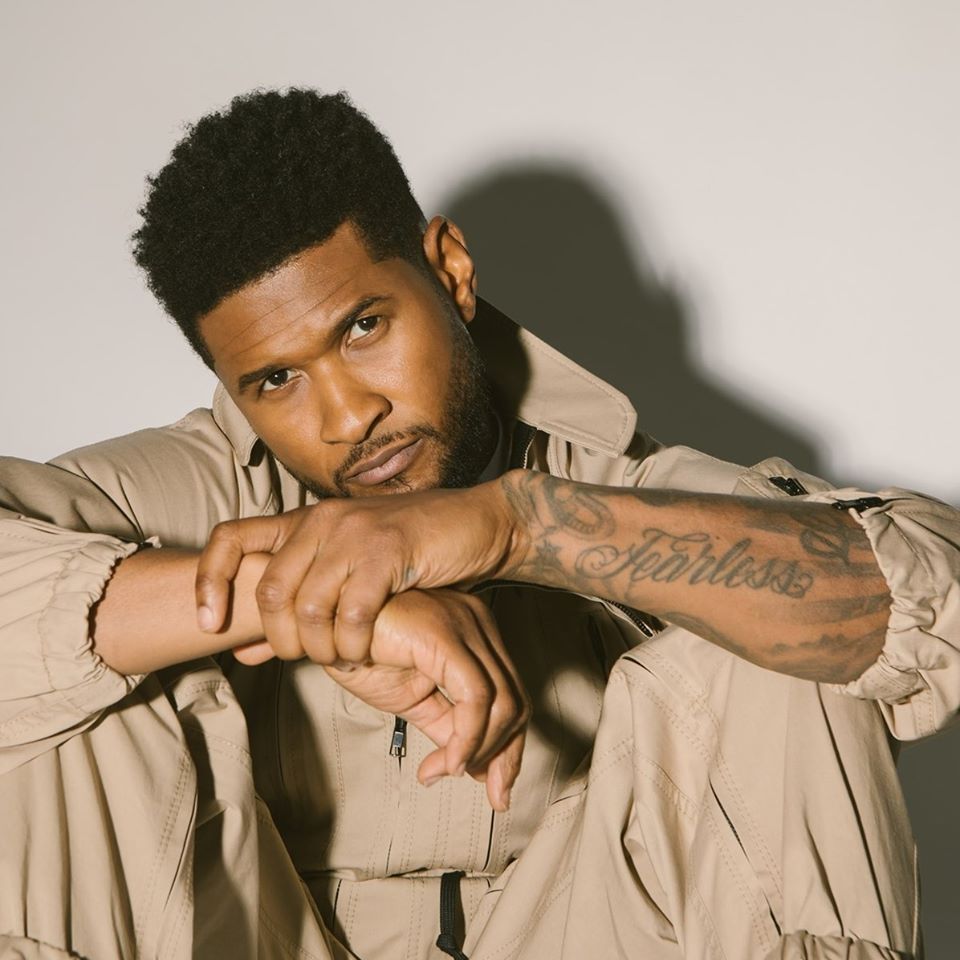 Usher showing his tattooed forearm