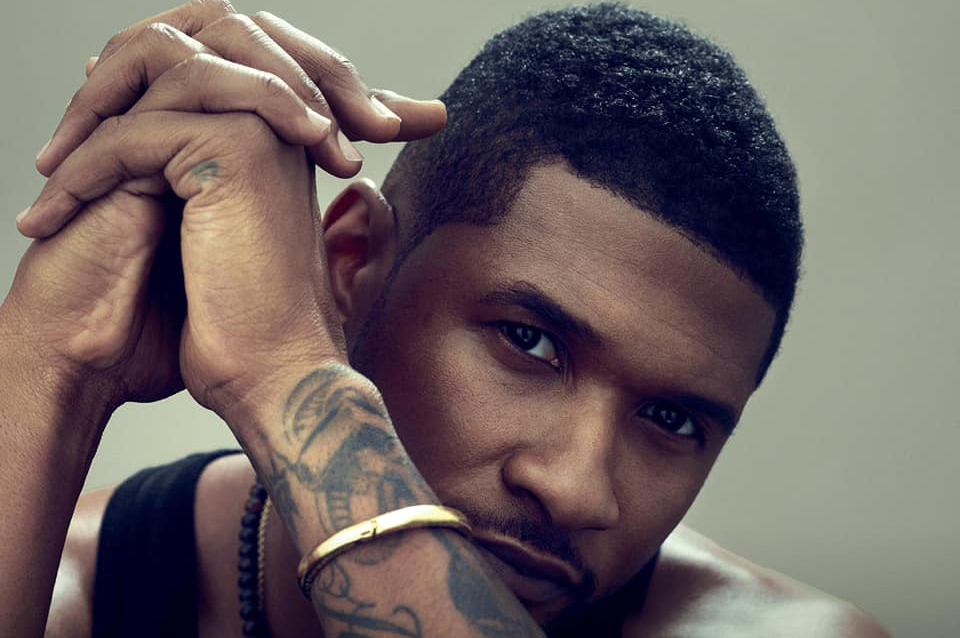 Usher forearm tattoos in a portrait