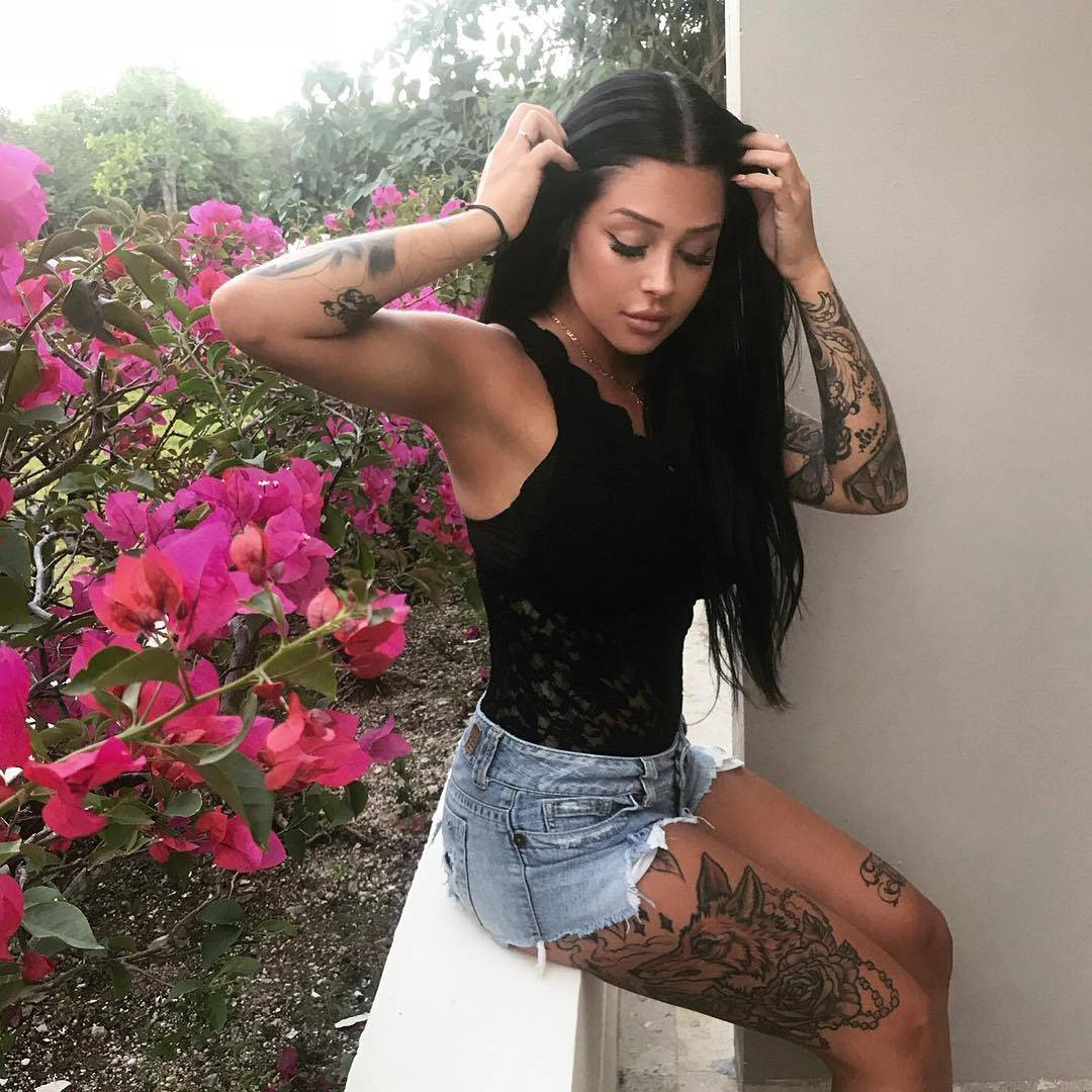 Valerie Cossette thigh wolf roses and beads tattoo