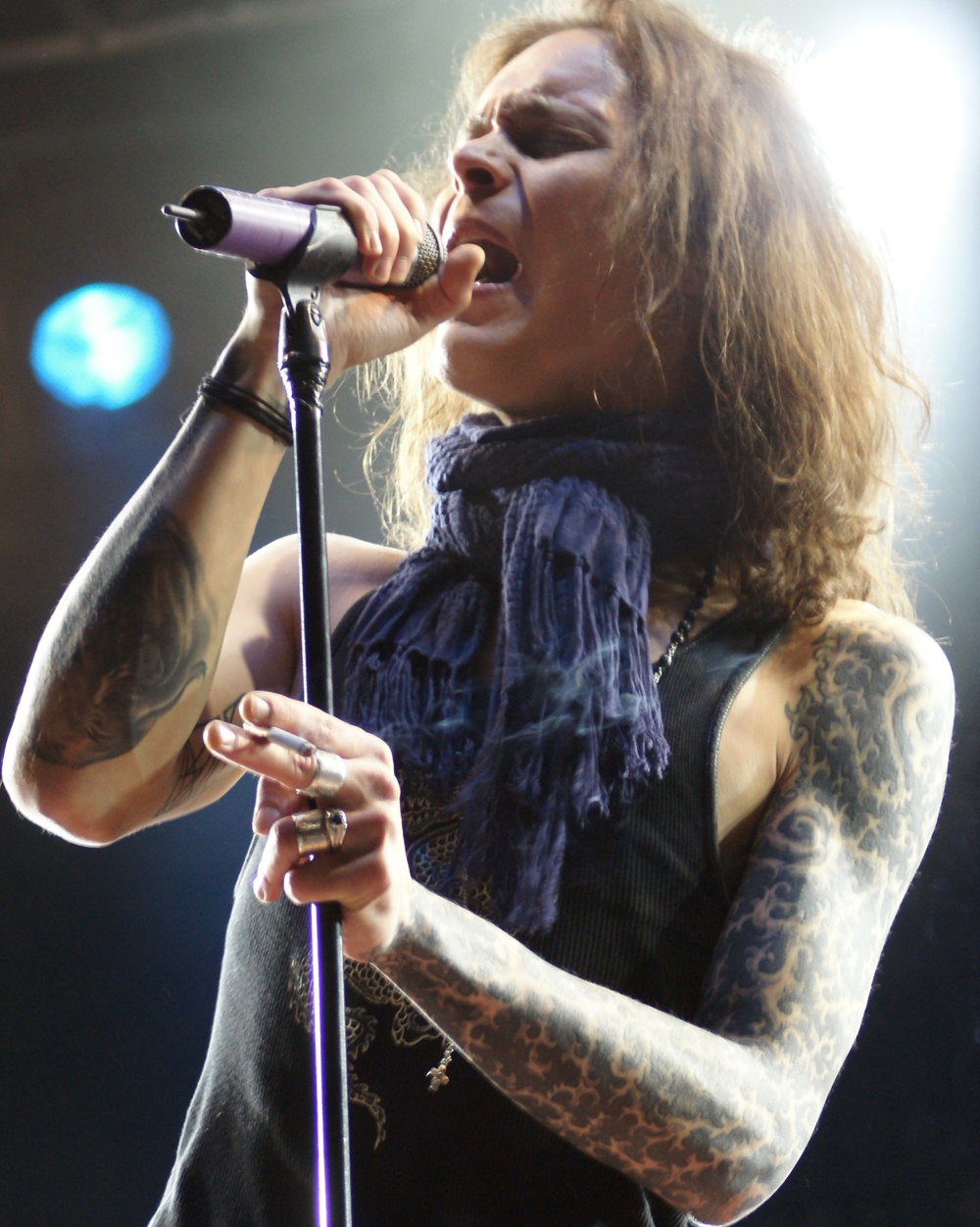 Ville Valo tattoos: performance portrait showing the full ornamental sleeve and upper arm tattoo texture