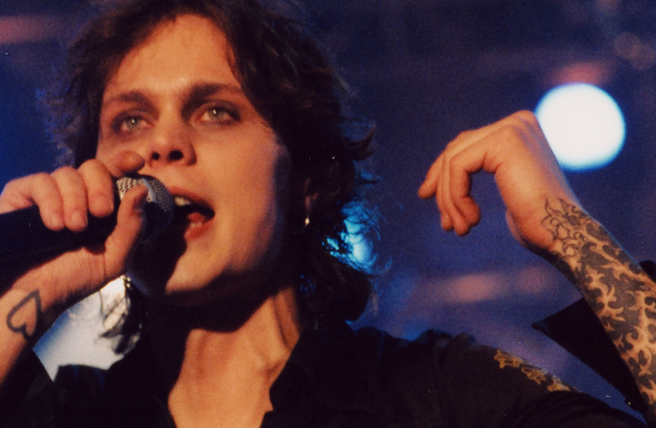 Ville Valo tattoos: close performance photograph showing the Heartagram area and both tattooed forearms