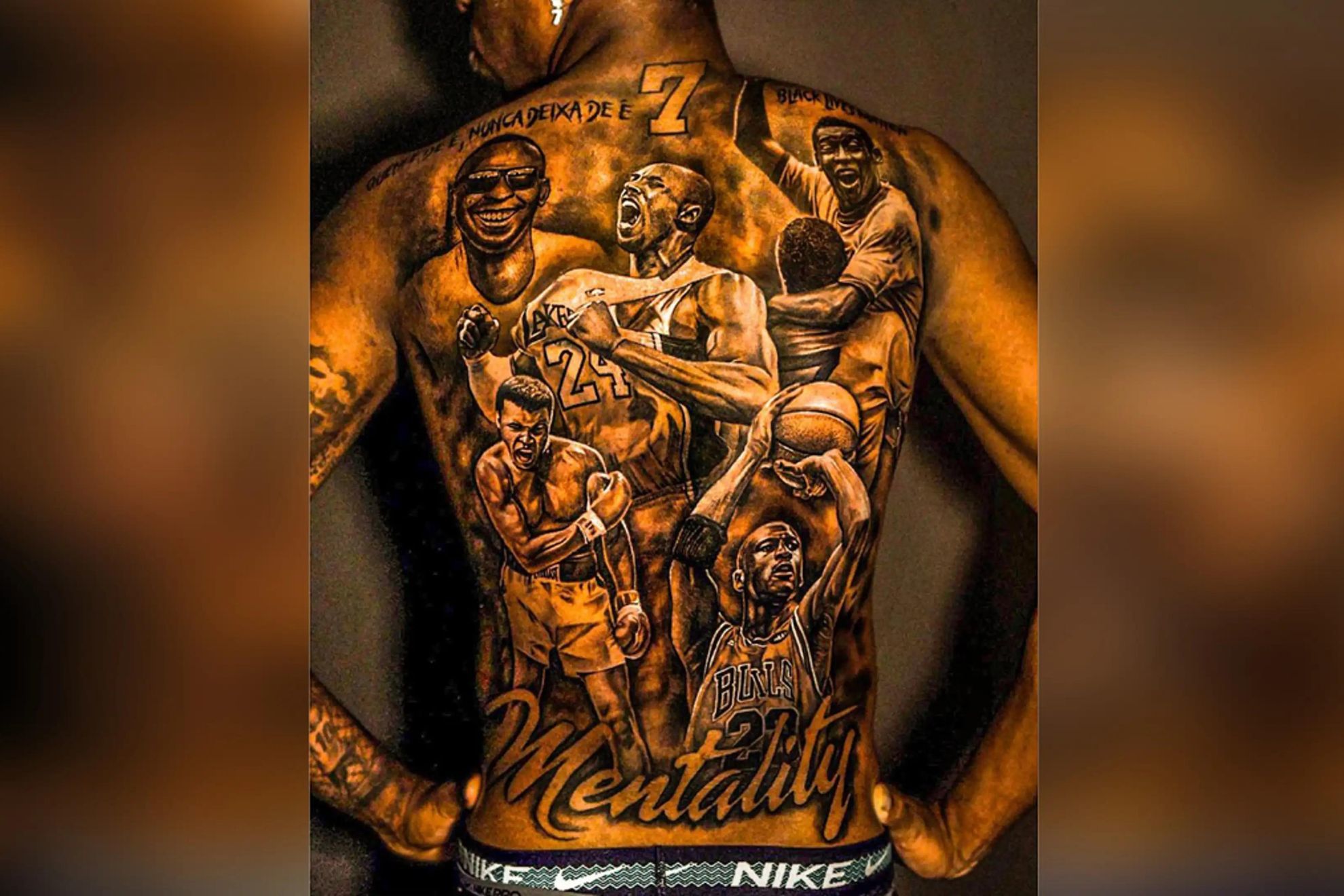 Vinícius Júnior High-resolution full-back view showing the upper number, shoulder lettering and lower Mentality script Vinícius Júnior tattoos: High-resolution full-back view showing the upper number, shoulder lettering and lower Mentality script