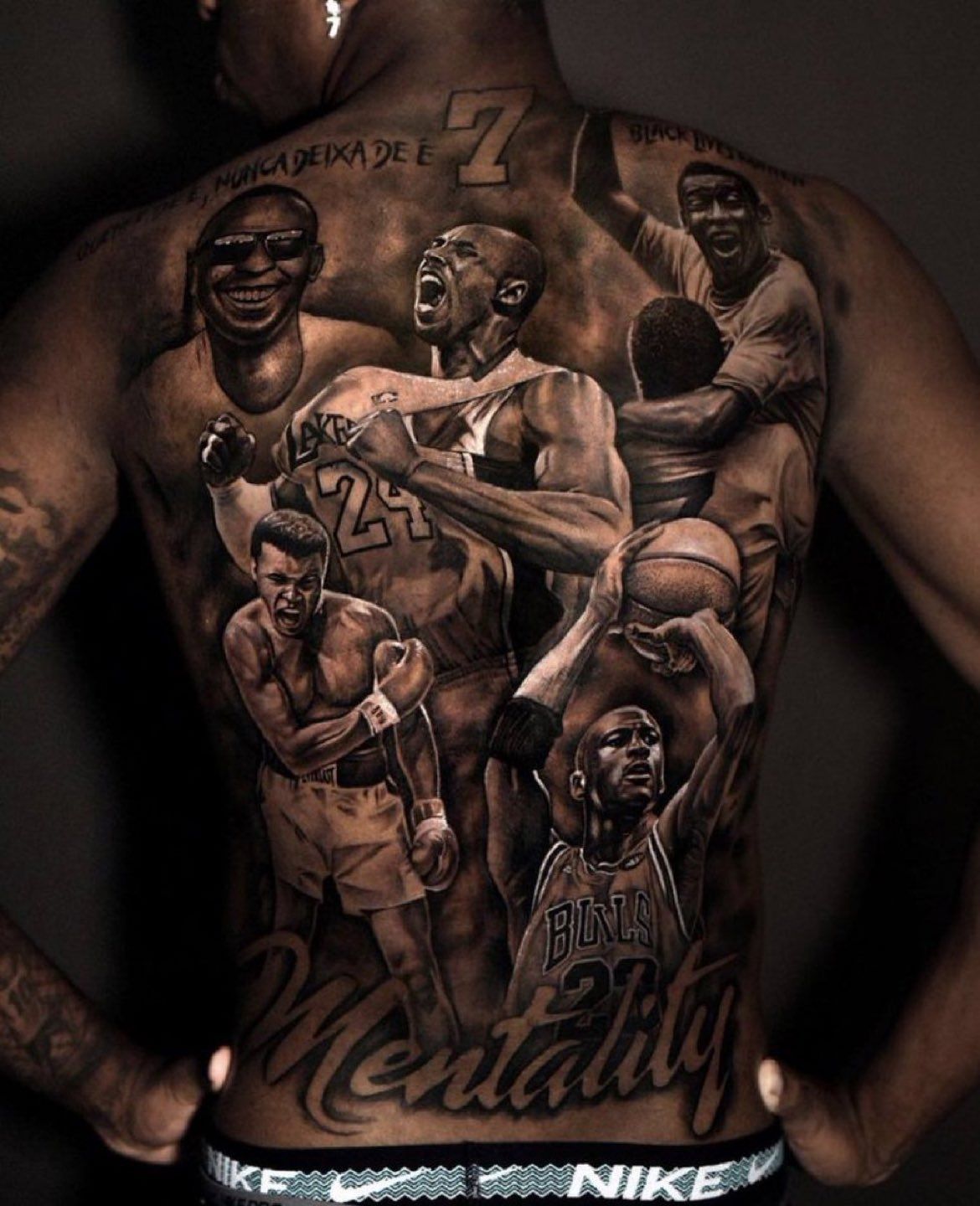 Vinícius Júnior Upper-back view emphasizing the Pelé portrait, shoulder phrase and central portrait arrangement Vinícius Júnior tattoos: Upper-back view emphasizing the Pelé portrait, shoulder phrase and central portrait arrangement