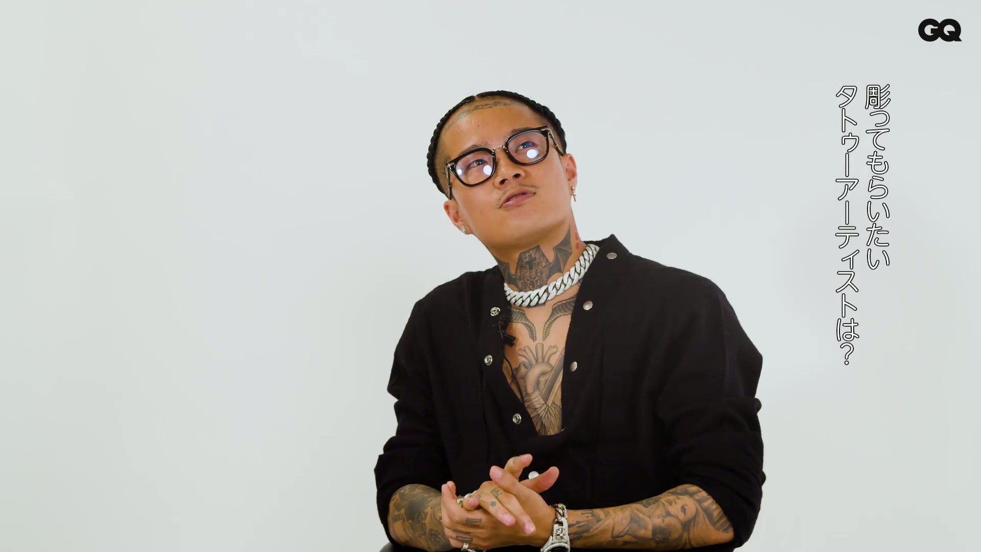 Vingo face and neck tattoo details Vingo tattoos: Face-and-neck frame documenting Vingo's compact forehead lettering, neck symbols and smaller marks beside the eye.