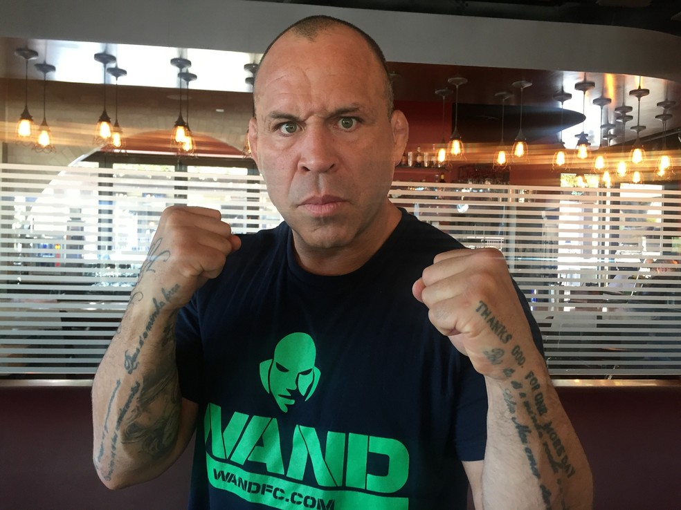 Wanderlei Silva tattoos: Portuguese prayer lettering visible on both forearms in a fighting pose