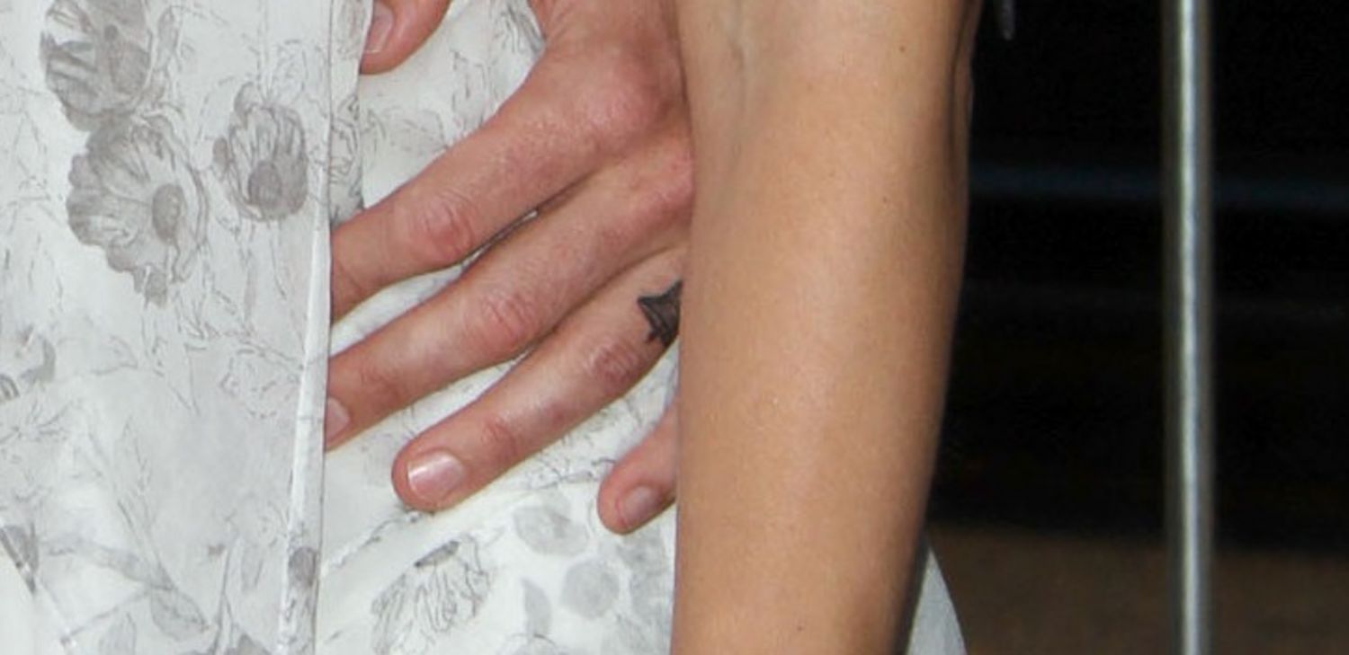 Dax Shepard tattoos: close-up photograph isolating the small bell tattoo on his ring finger