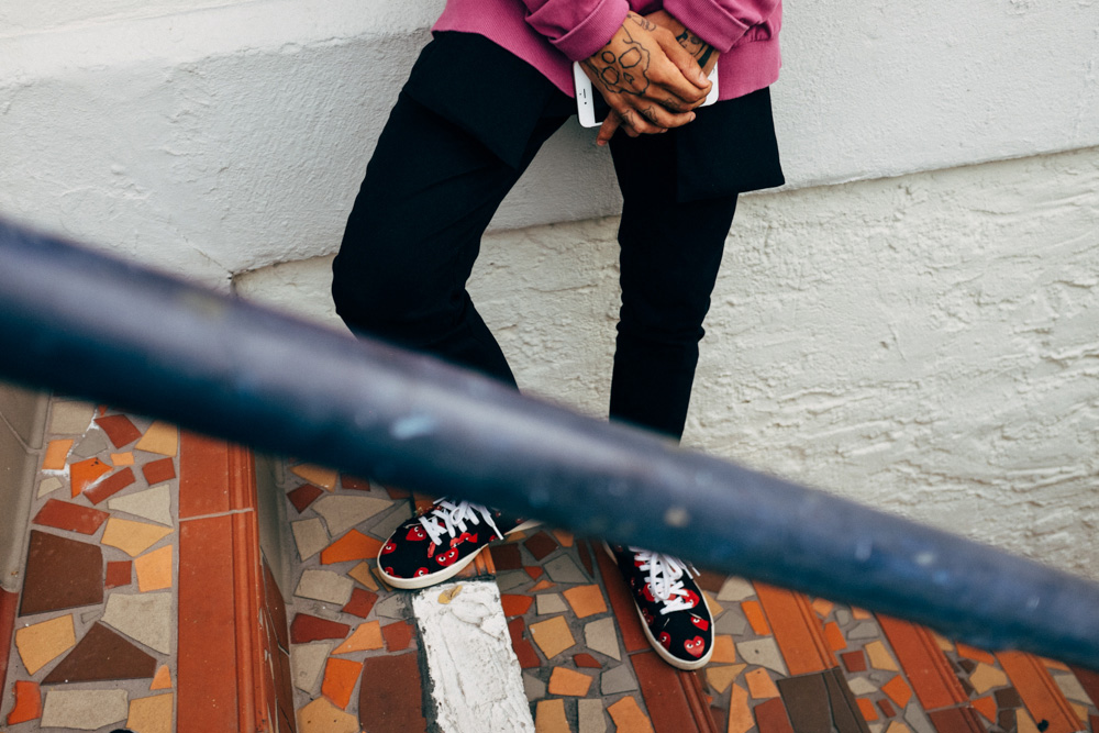 Wifisfuneral tattoos: tattooed hands and fingers shown clearly around a phone