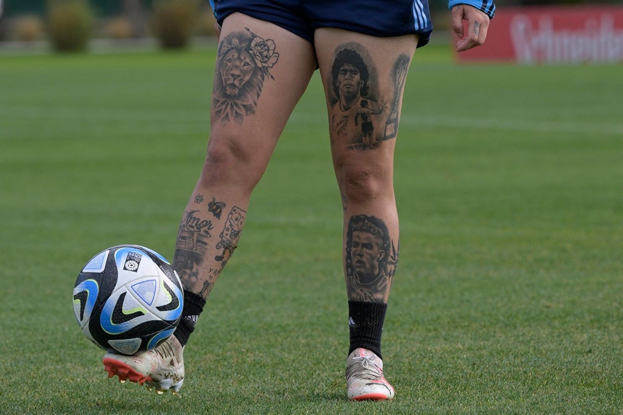 Yamila Rodriguez tattoos: Genuine single lower-body training photograph showing the collection as a connected leg layout.