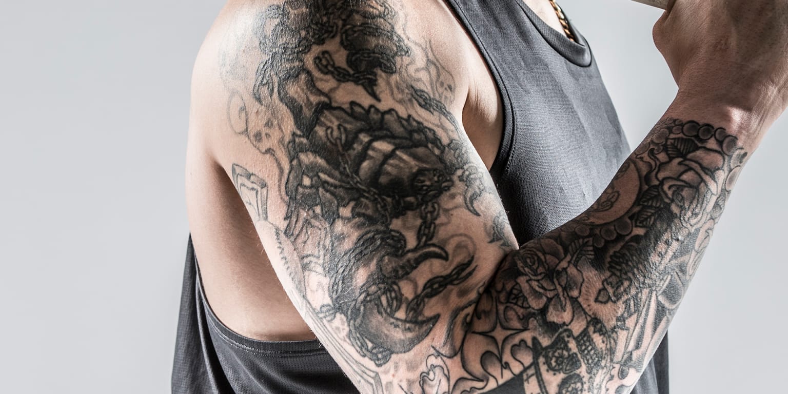 Yasmani Grandal tattoos: Right upper-arm scorpion wrapped in broken and intact chains