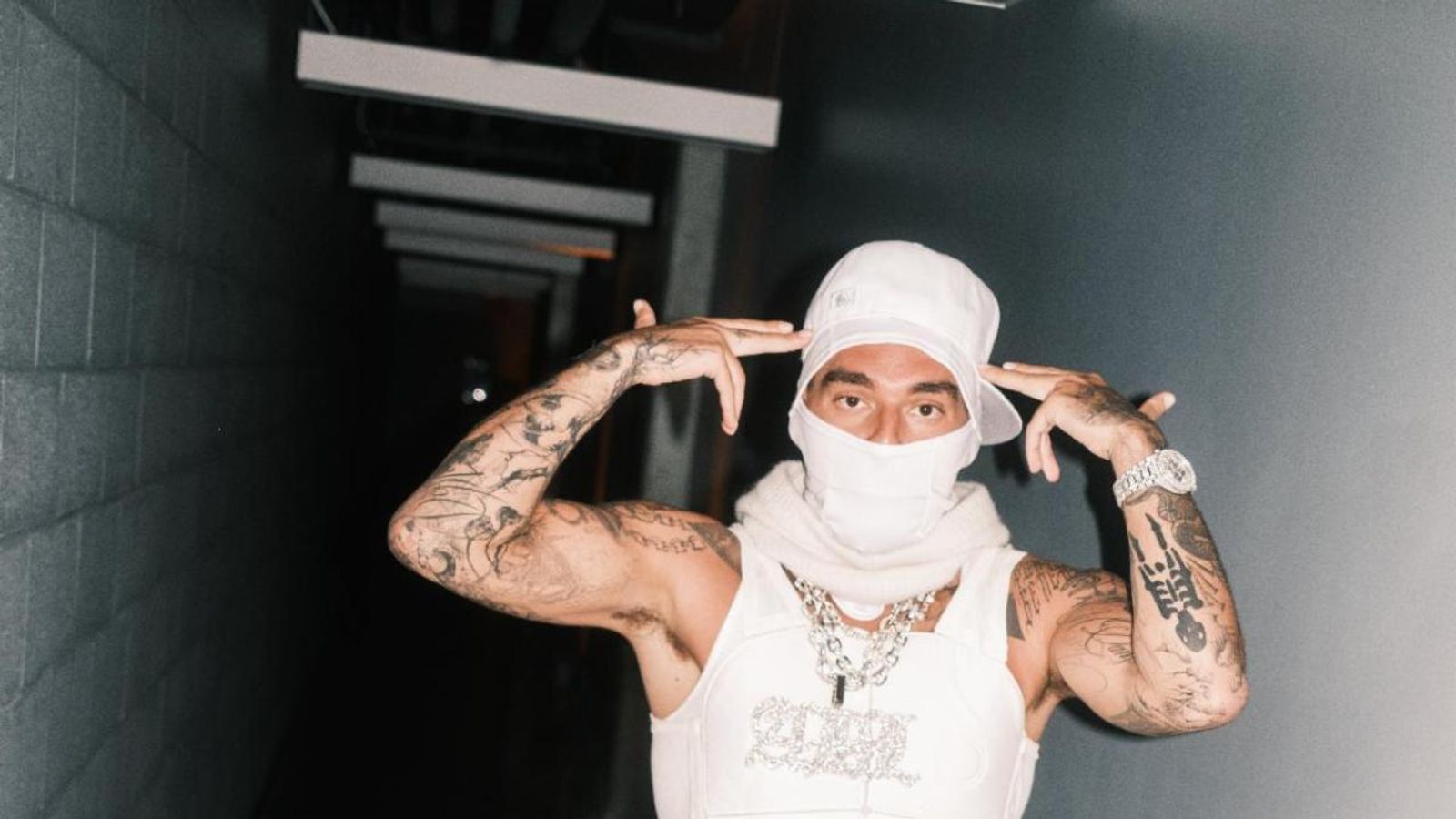 Yeat tattoos: both arms lifted with visible tattoos