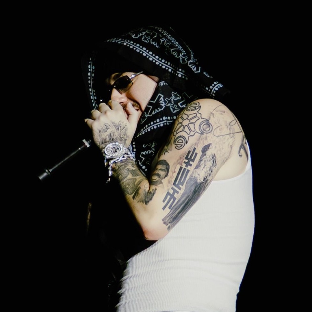 Yeat tattoos: tattooed arms during a live performance