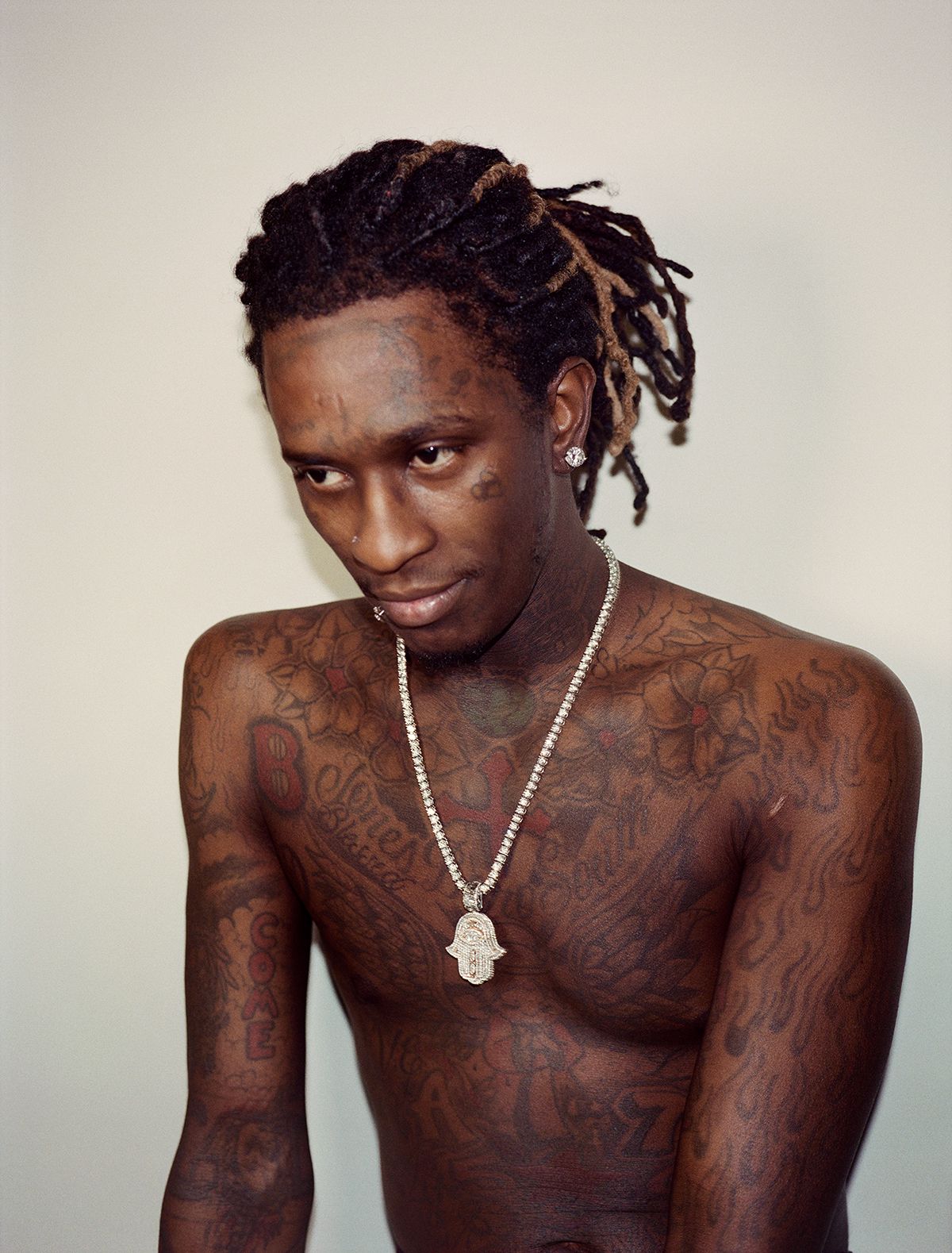 Young Thug chest and arm tattoos