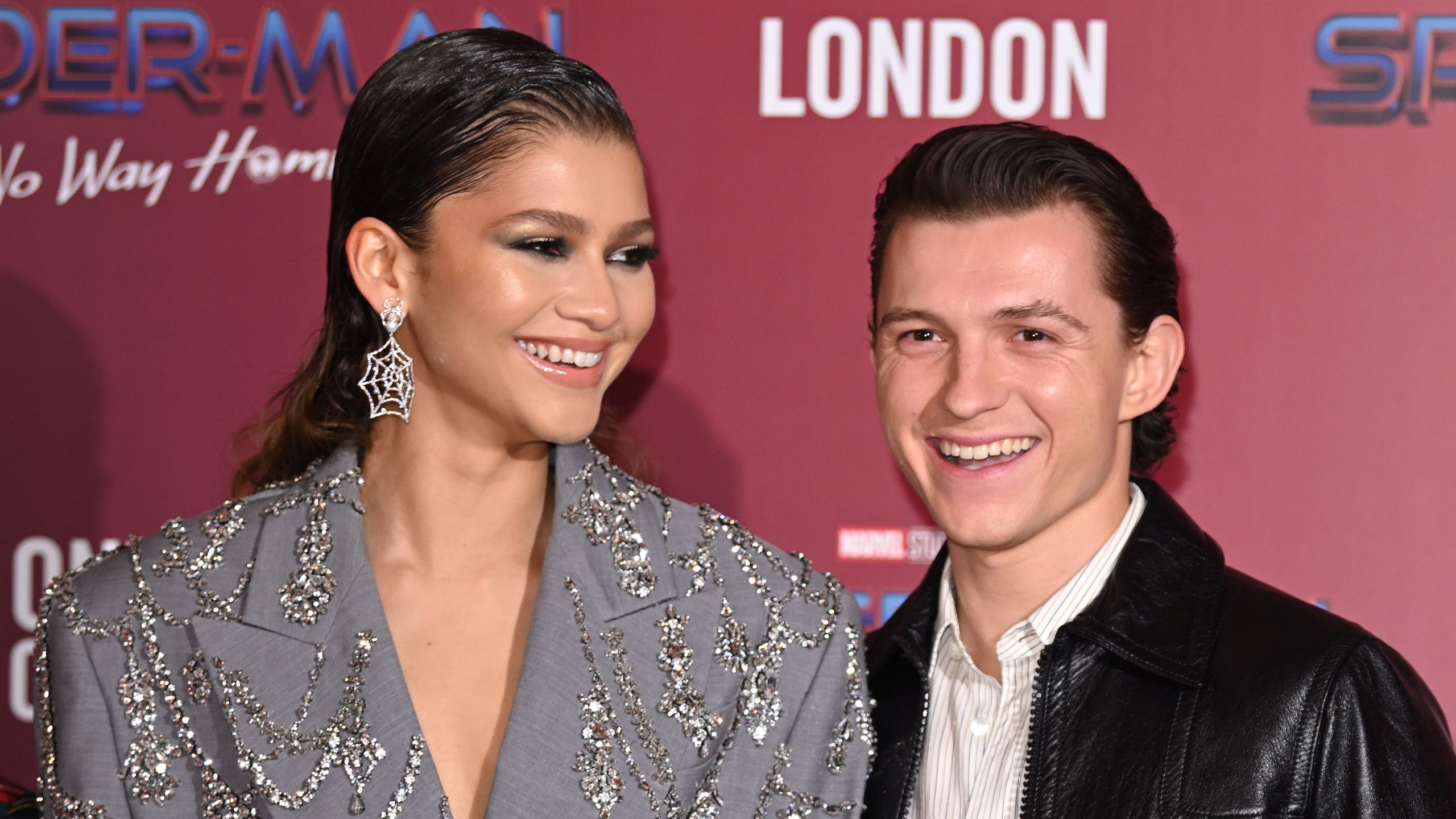 Zendaya at a Spider-Man photocall (contextual, not tattoo evidence) Zendaya in a contextual photograph: Contextual Spider-Man photocall image of Zendaya with Tom Holland; it does not show tattoo evidence.; not tattoo evidence