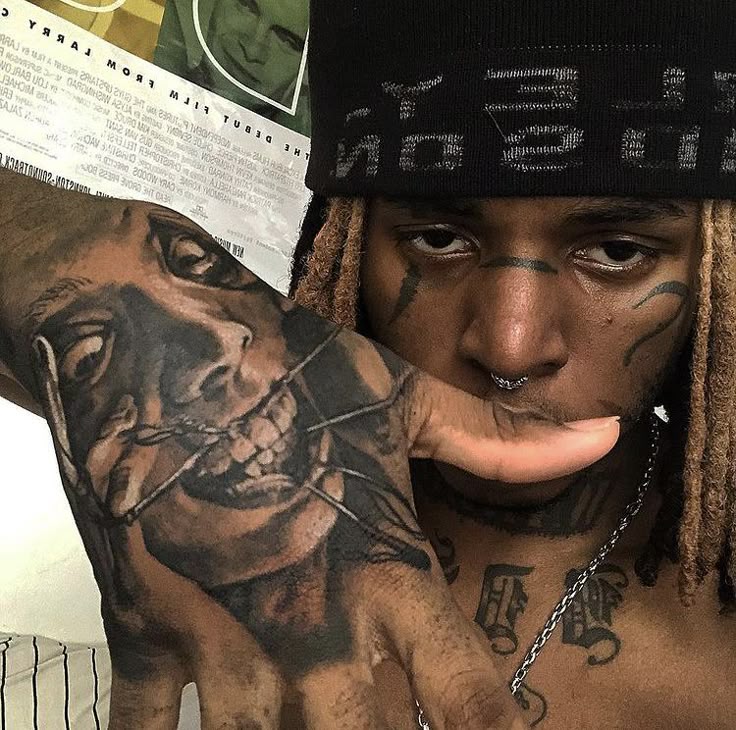 ZillaKami hand and face tattoos